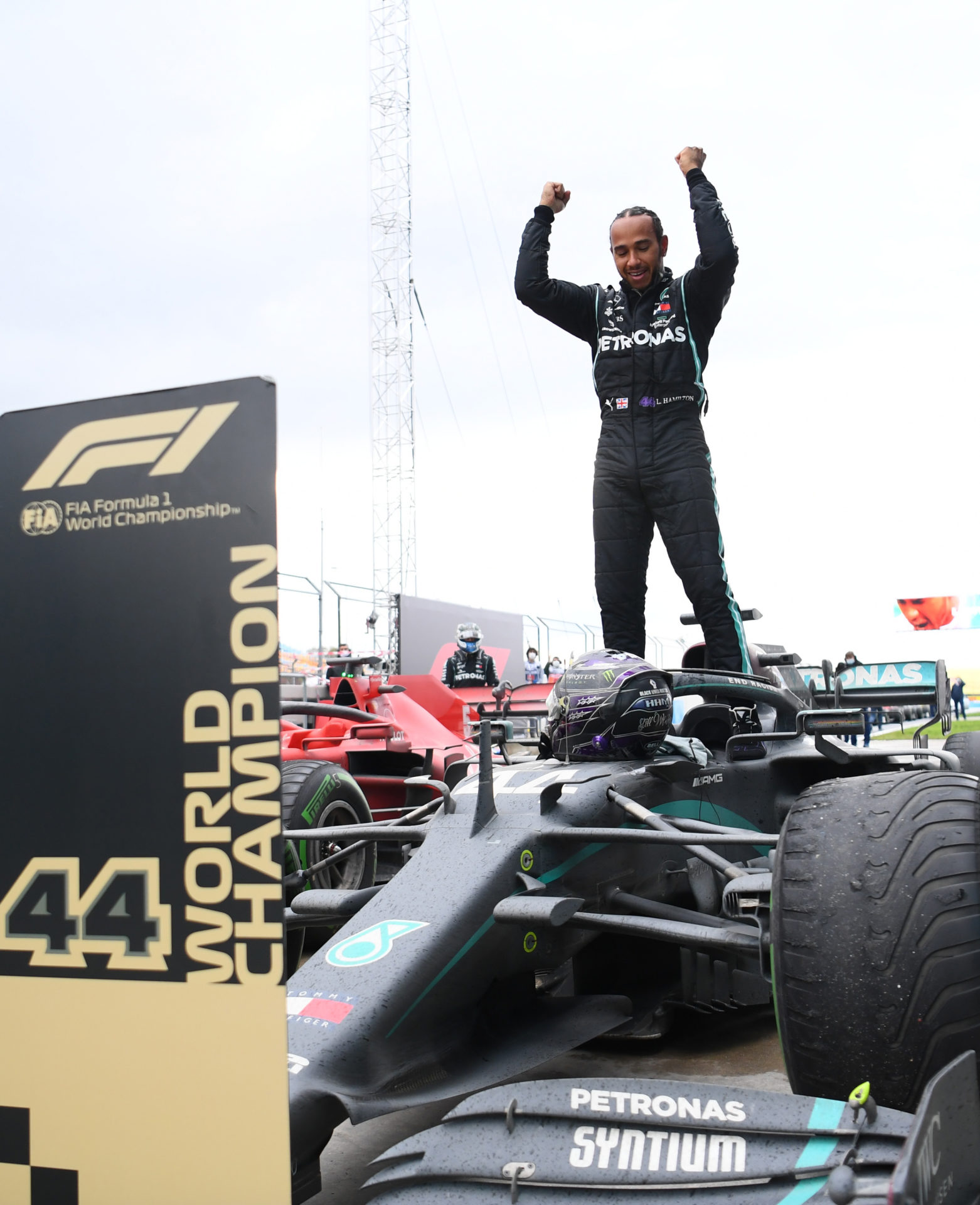 Lewis Hamilton stands atop his Mercedes in Parc Ferme to celebrate his victory in Turkey