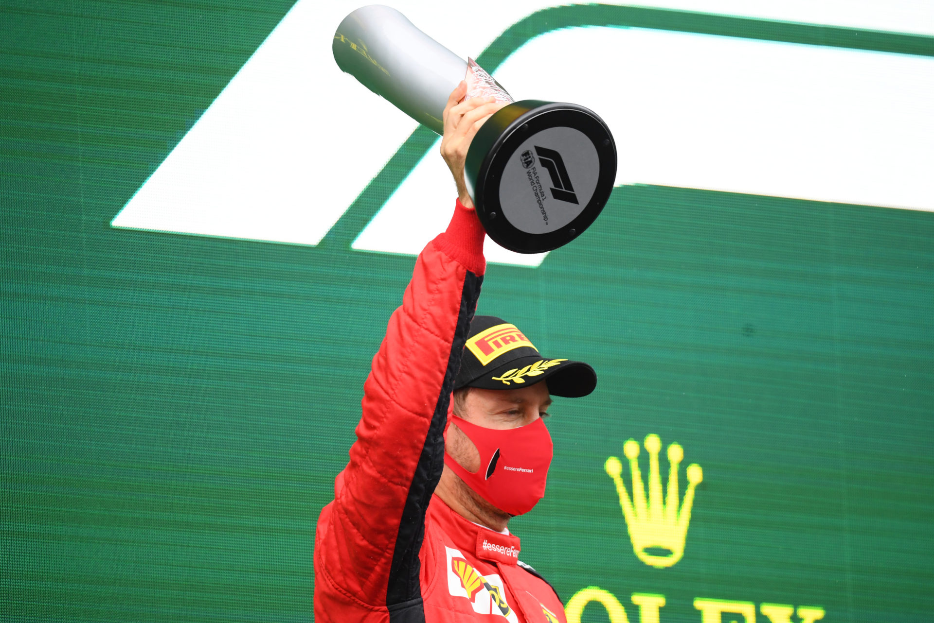 Ferrari driver Sebastian Vettel holds his trophy aloft after securing P3 in Turkey