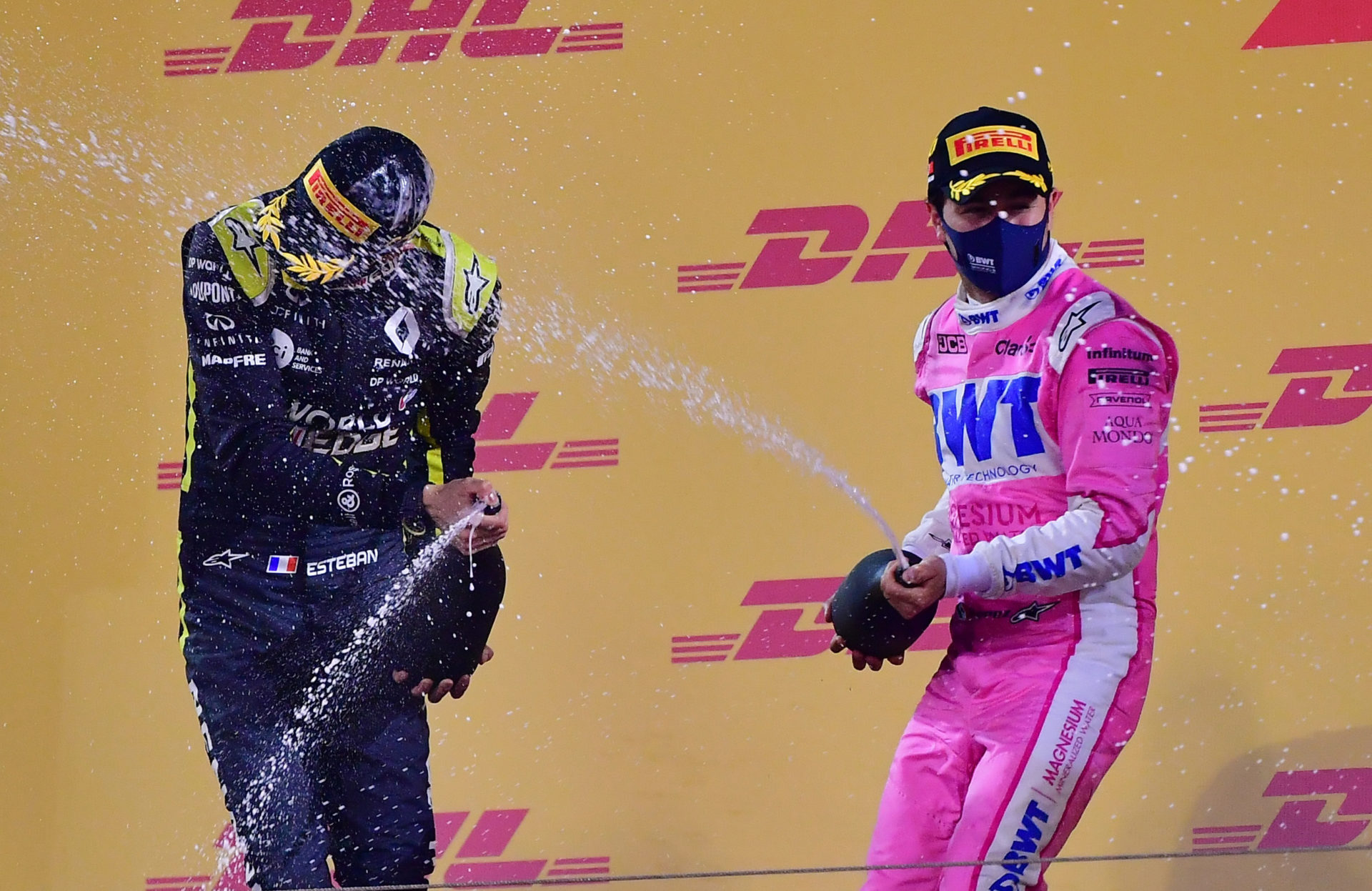 Renault racer Esteban Ocon and Sergio Perez celebrating on the podium