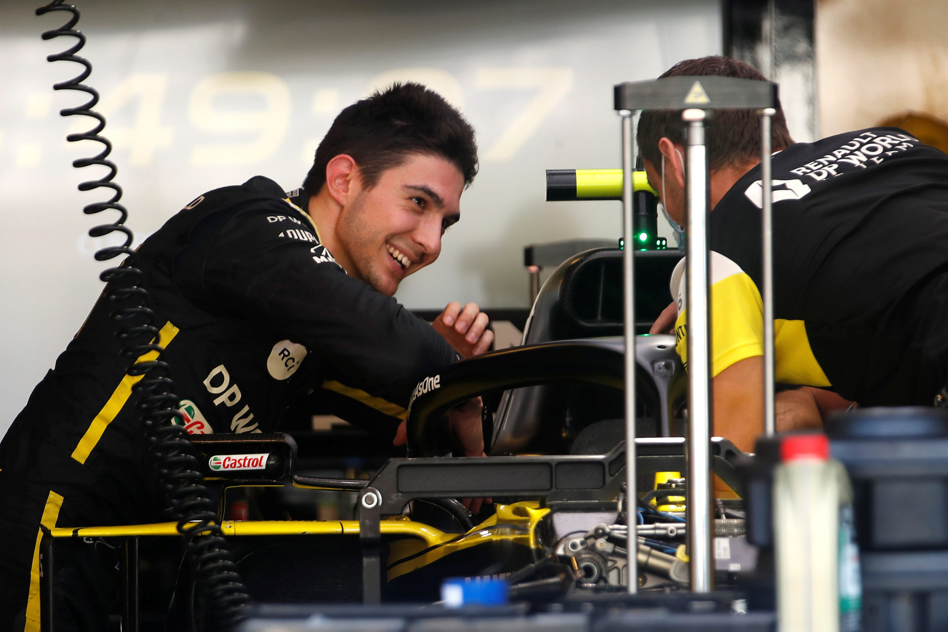Esteban Ocon chatting with his engineer in the Renault's pitbox
