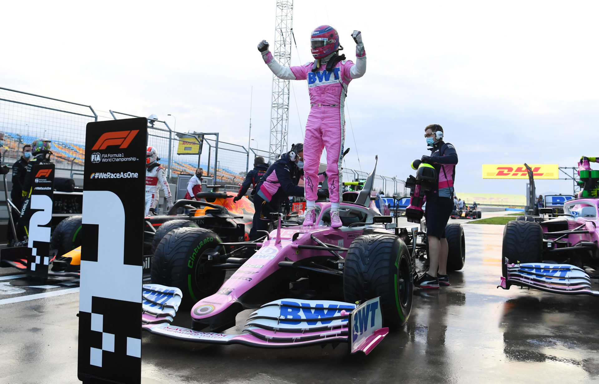 Lance Stroll stands atop his car to celebrate his pole position at Istanbul Park