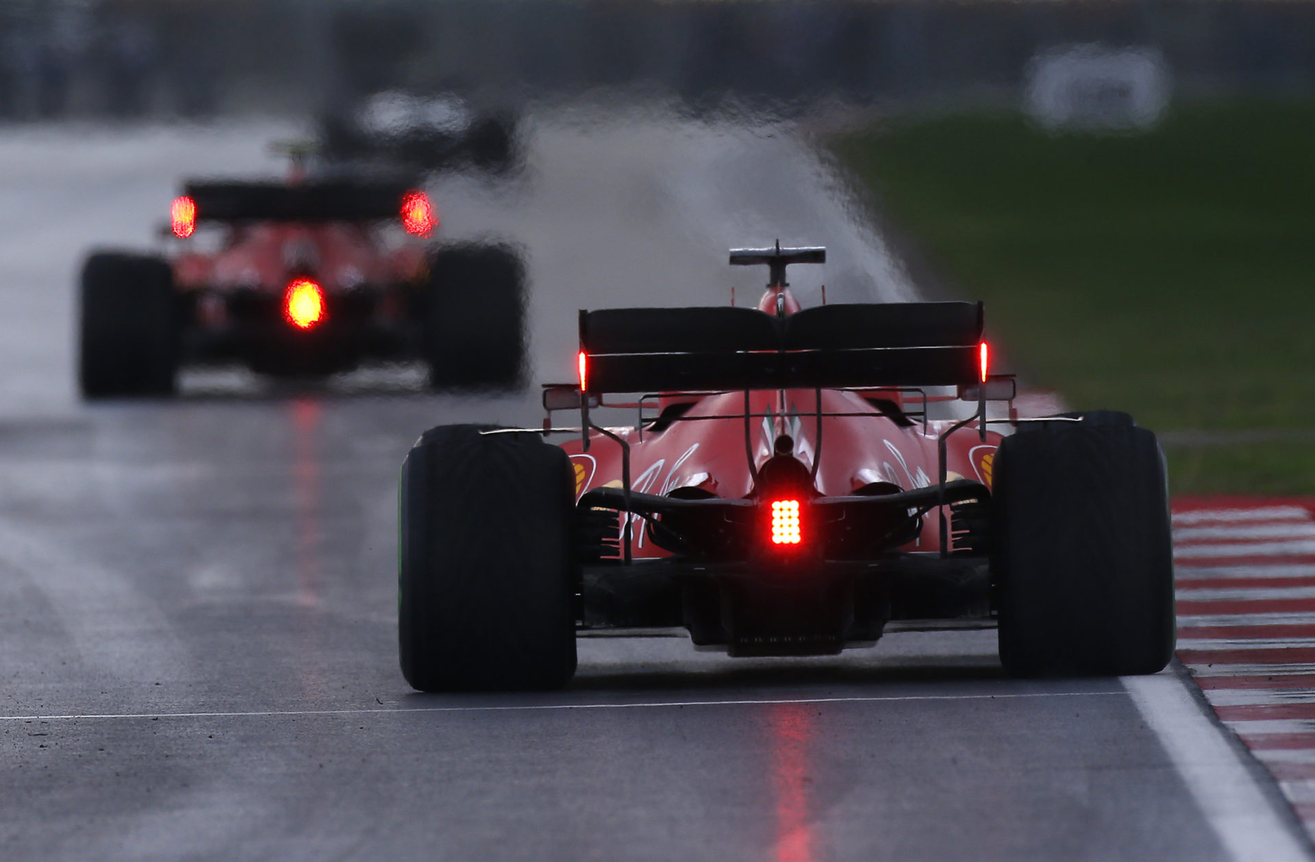 Ferrari F1 pilot Sebastian Vettel in action at the Turkish Grand Prix race 2020, the cockpits with their rear red lights on for safety measures.