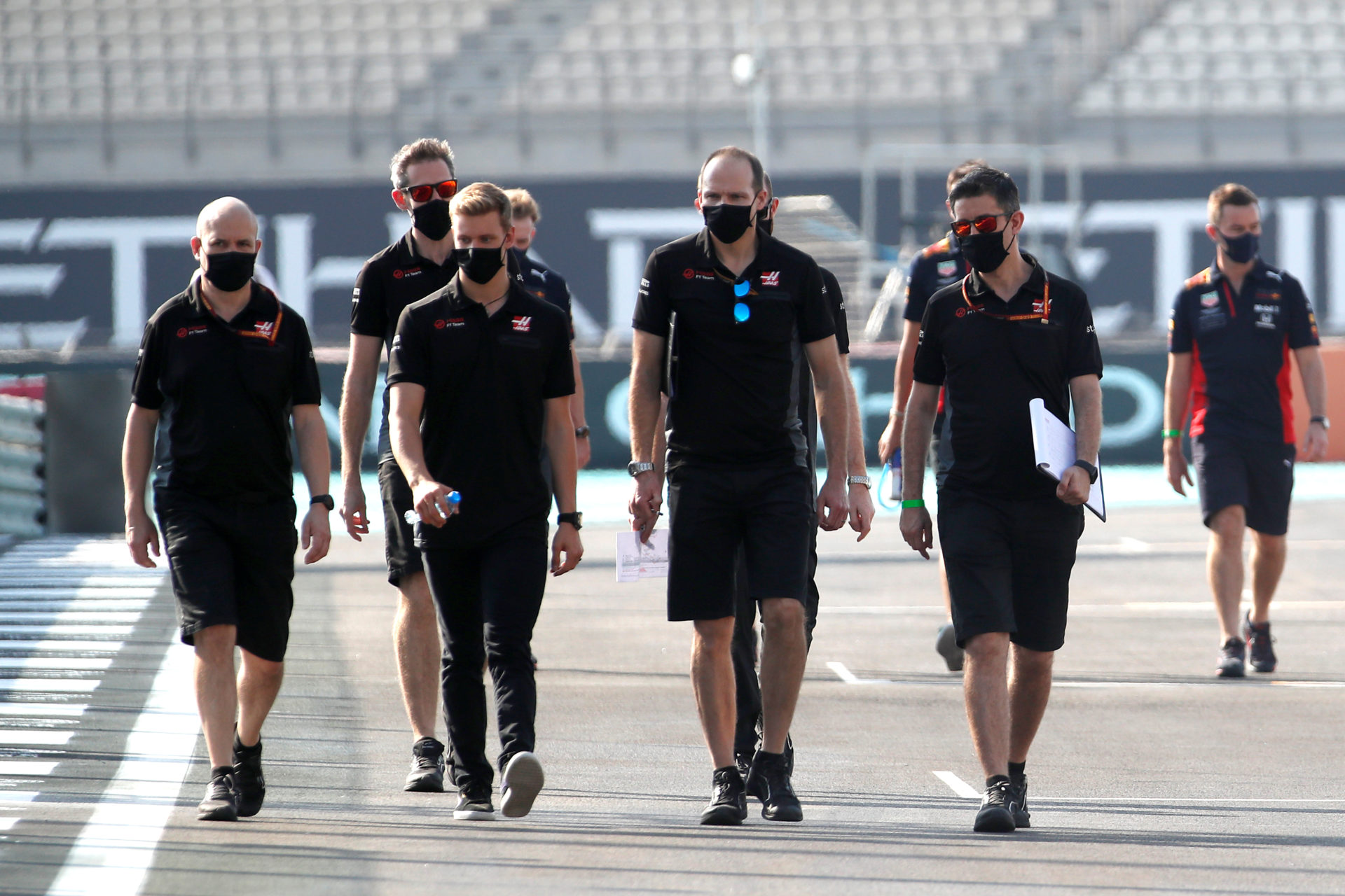 Mick Schumacher walking with Haas' crew on Yas Marina Circuit