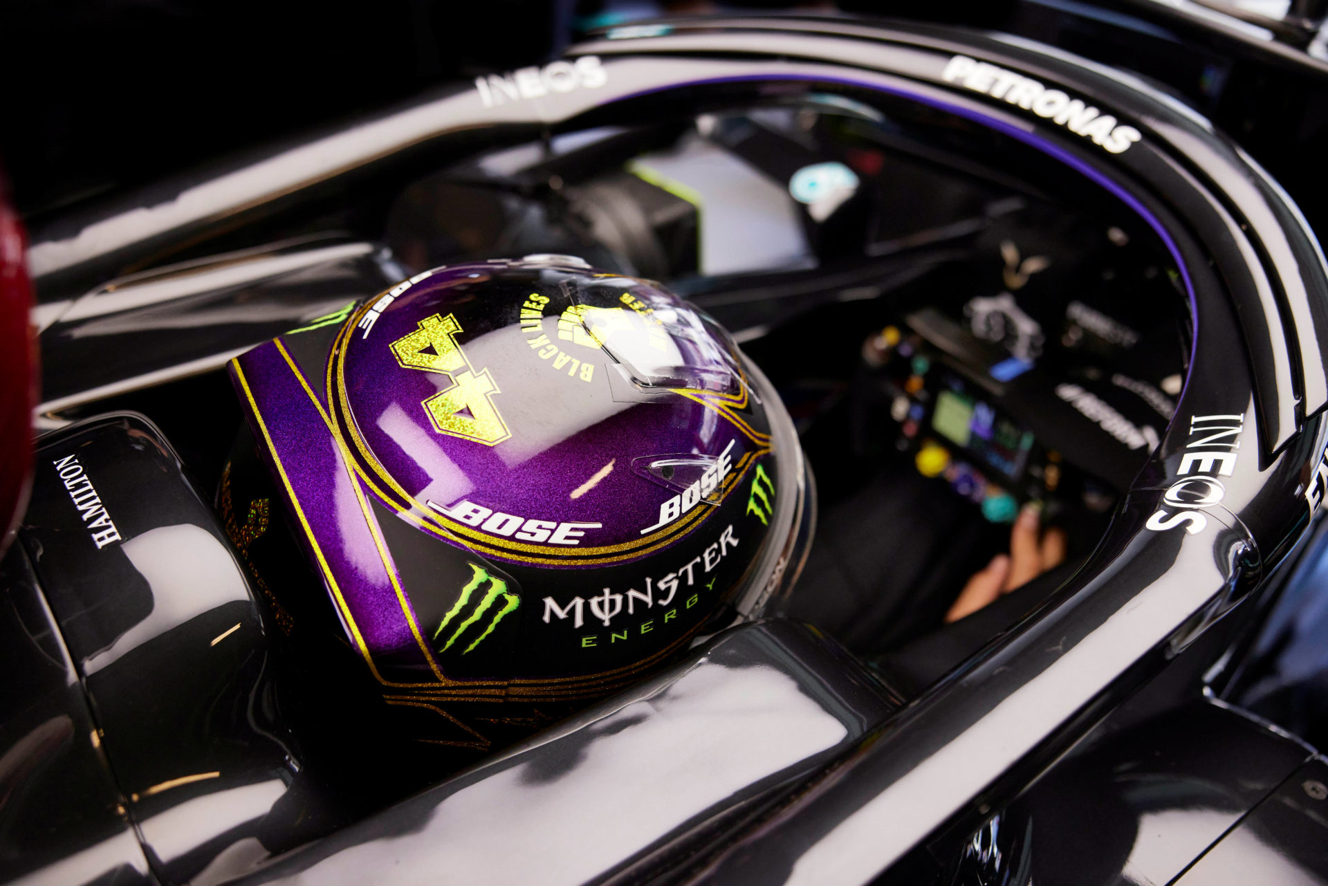 F1 Driver Lewis Hamilton in his Mercedes car's cockpit at Abu Dhabi Grand Prix 2020. The helmet and the protection kit adds on extra pressure on the racer and their neck.