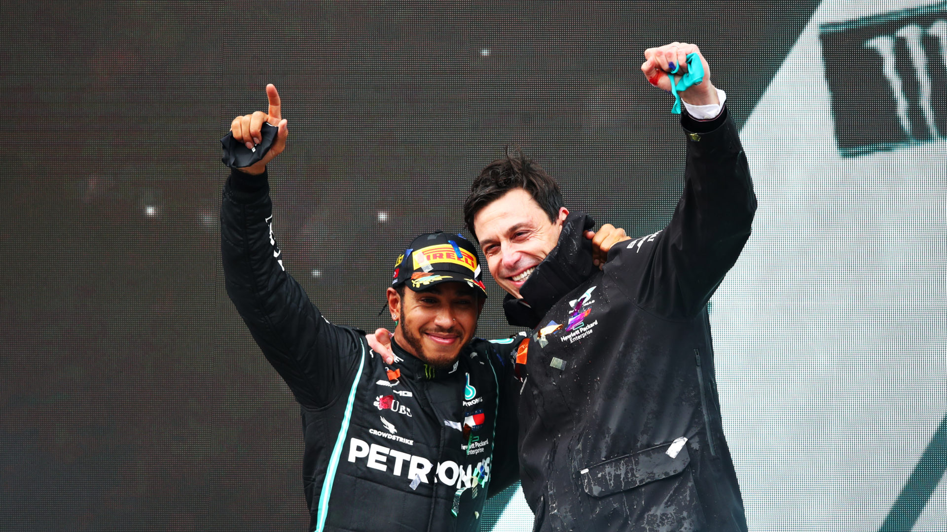 Mercedes' Lewis Hamilton celebrating Championship win with Toto Wolff on the podium