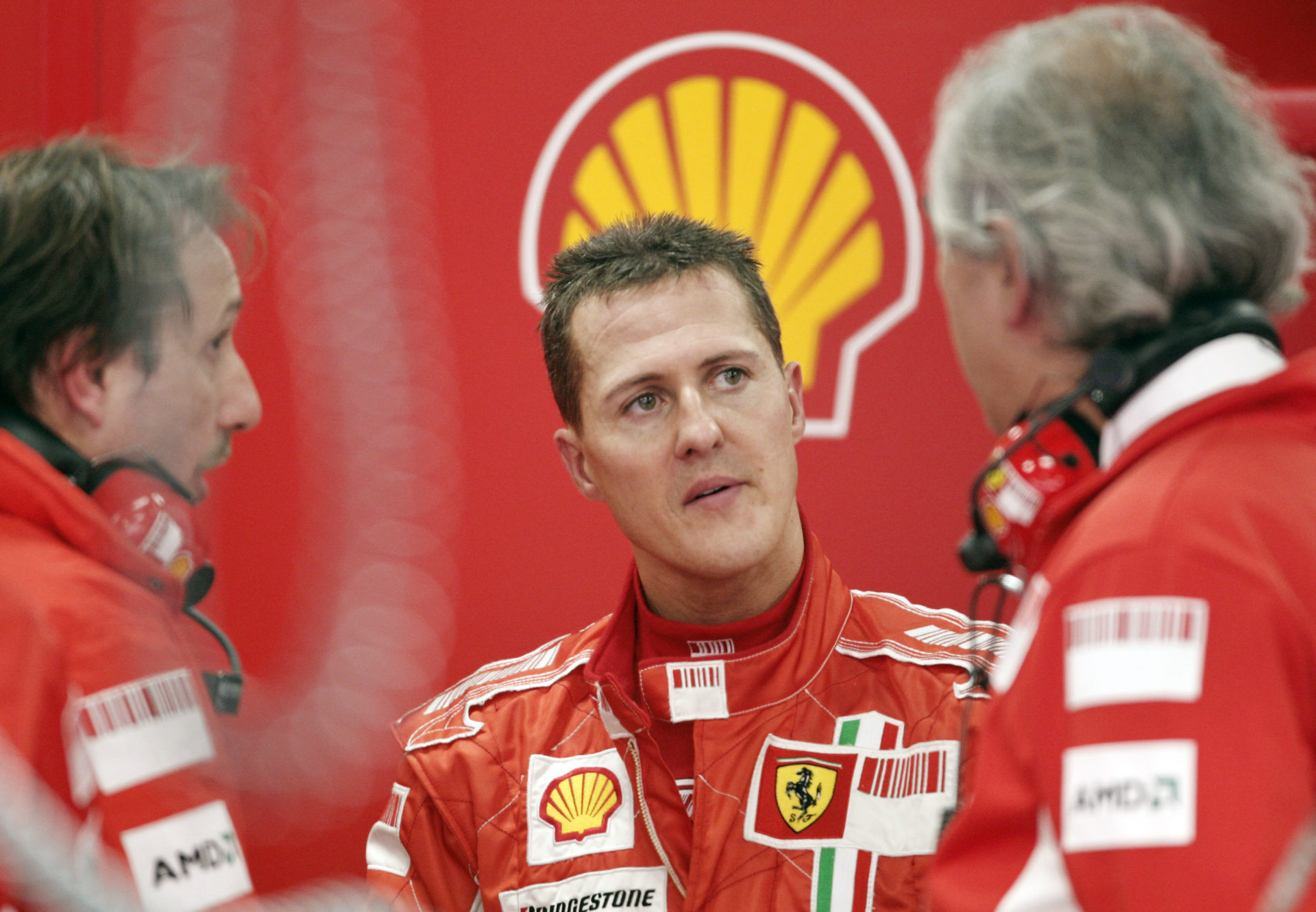 Ferrari driver Michael Schumacher speaking to his engineers in the team's garage