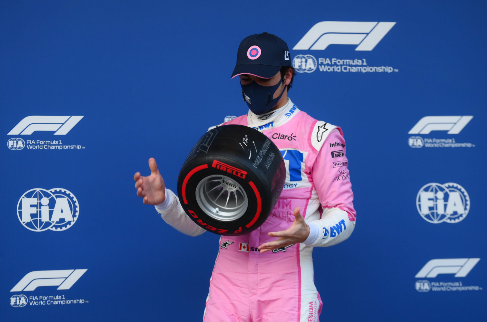 Lance Stroll juggles the pole position tyre trophy at Istanbul Park