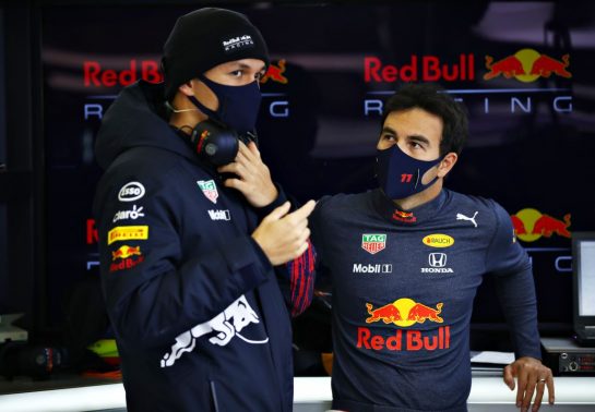 NORTHAMPTON, ENGLAND - FEBRUARY 24: Sergio Perez of Mexico and Red Bull Racing talks with Alexander Albon of Thailand and Red Bull Racing in the garage during the Red Bull Racing Filming Day at Silverstone on February 24, 2021 in Northampton, England. (Photo by Mark Thompson/Getty Images for Red Bull Racing) // Getty Images / Red Bull Content Pool // SI202102240150 // Usage for editorial use only //
