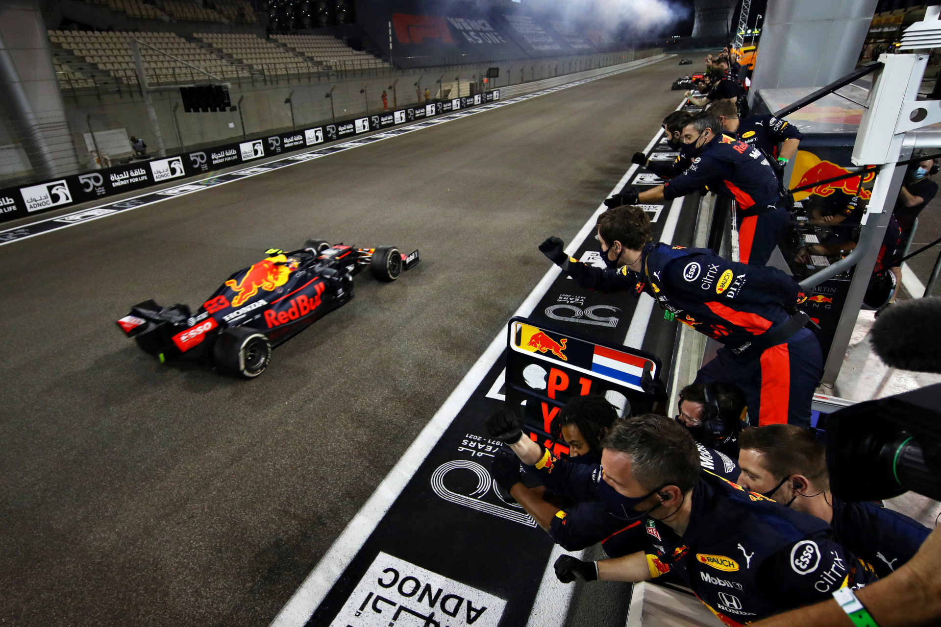 Red Bull driver Alex Albon crosses the chequered line at Abu Dhabi