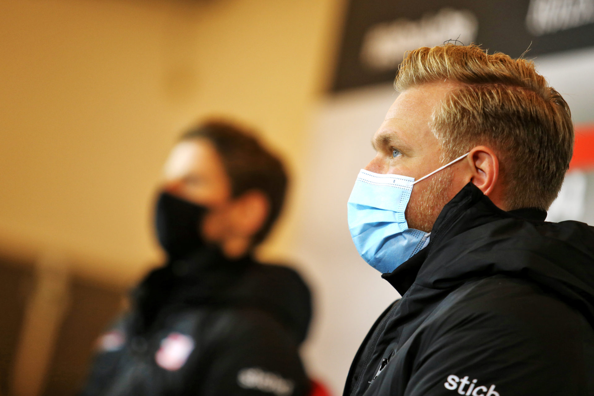 Haas F1's Kevin Magnussen in the foreground with Romain Grosjean in the background at a press conference prior to the race in Germany
