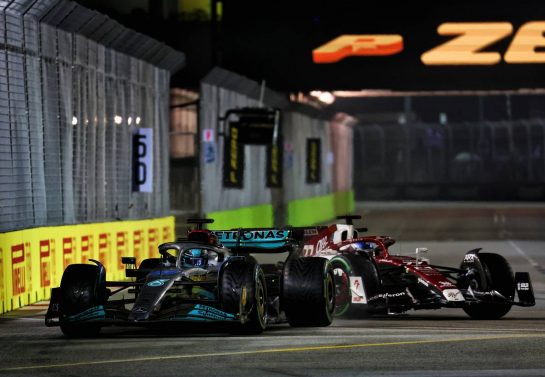 (L to R): George Russell (GBR) Mercedes AMG F1 W13 and Valtteri Bottas (FIN) Alfa Romeo F1 Team C42 battle for position.
02.10.2022. Formula 1 World Championship, Rd 17, Singapore Grand Prix, Marina Bay Street Circuit, Singapore, Race Day.
 - www.xpbimages.com, EMail: requests@xpbimages.com &copy; Copyright: Coates / XPB Images